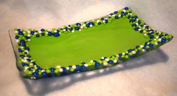 LIME GREEN CURVED DISH WITH BLUE, LIME, WHTE BALLS AT EDGES